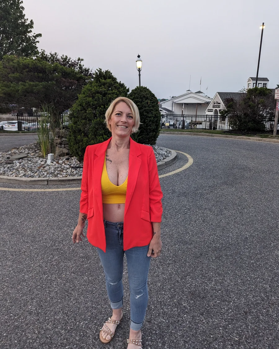 Amy smiling in a red blazer